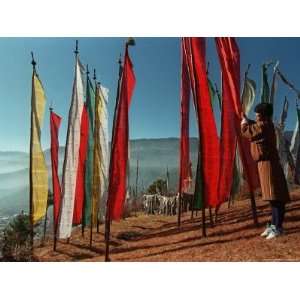  A Bhutanese Man Straightens a Prayer Flag at a Buddhist 