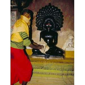 Jain Priest Cleaning a Jain Statue, Jaisalmer, Rajasthan State, India 