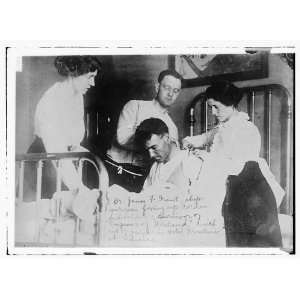  Photo Dr. James F. Grant, ships surgeon, fixing Gordon 