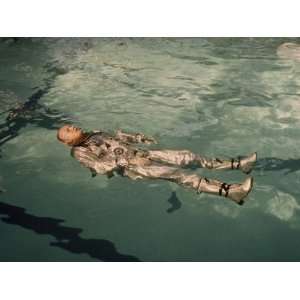 Astronaut Neil Armstrong Floats in His Space Suit in a Pool of Water 