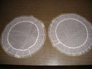 This is a set of of two round ruffled edged doilies. They are a light 