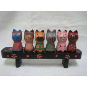 Six Wooden Bali cat sitting on a bench 