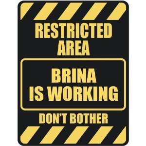   RESTRICTED AREA BRINA IS WORKING  PARKING SIGN